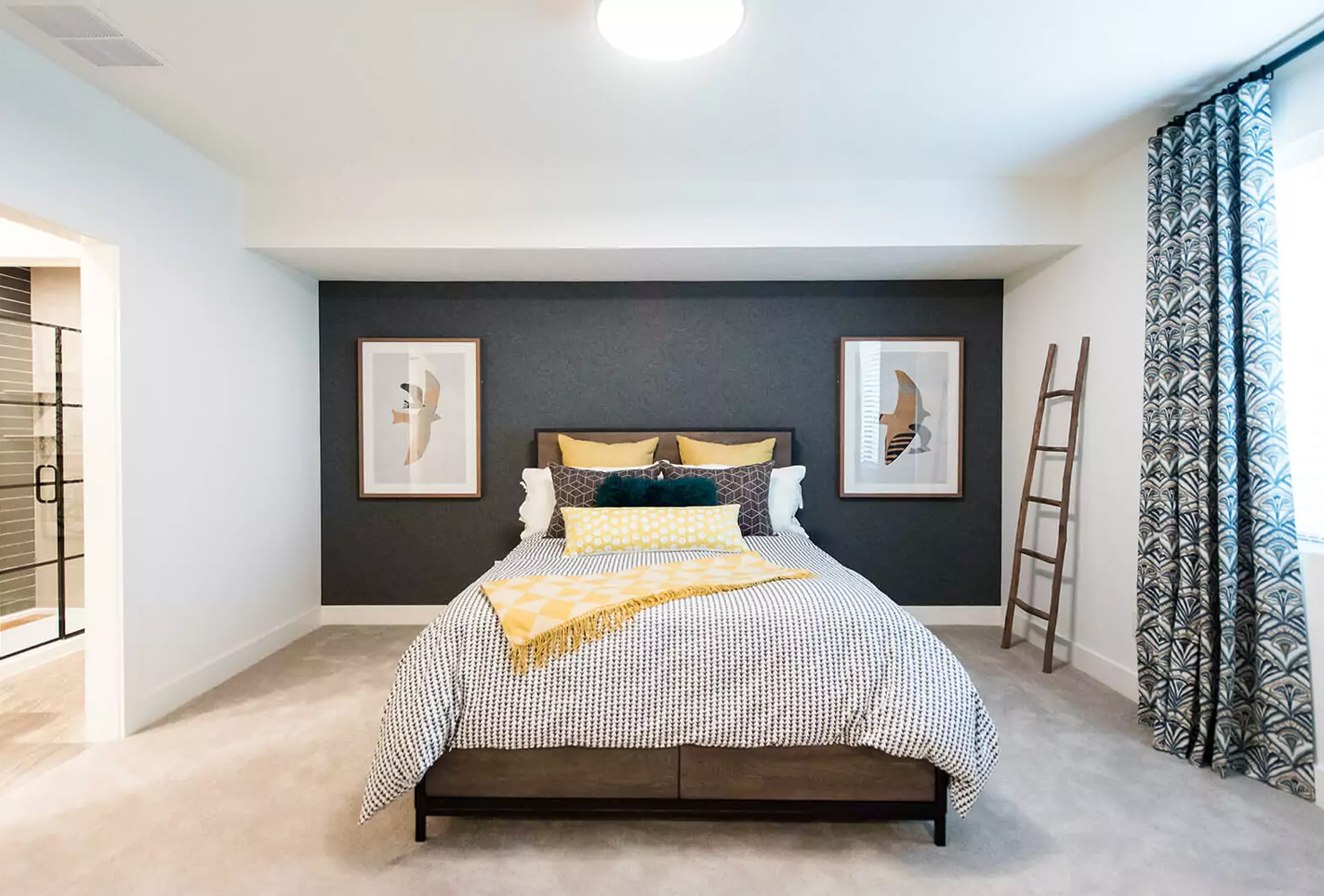 Basement converted into a cozy guest bedroom with a soothing color palette.